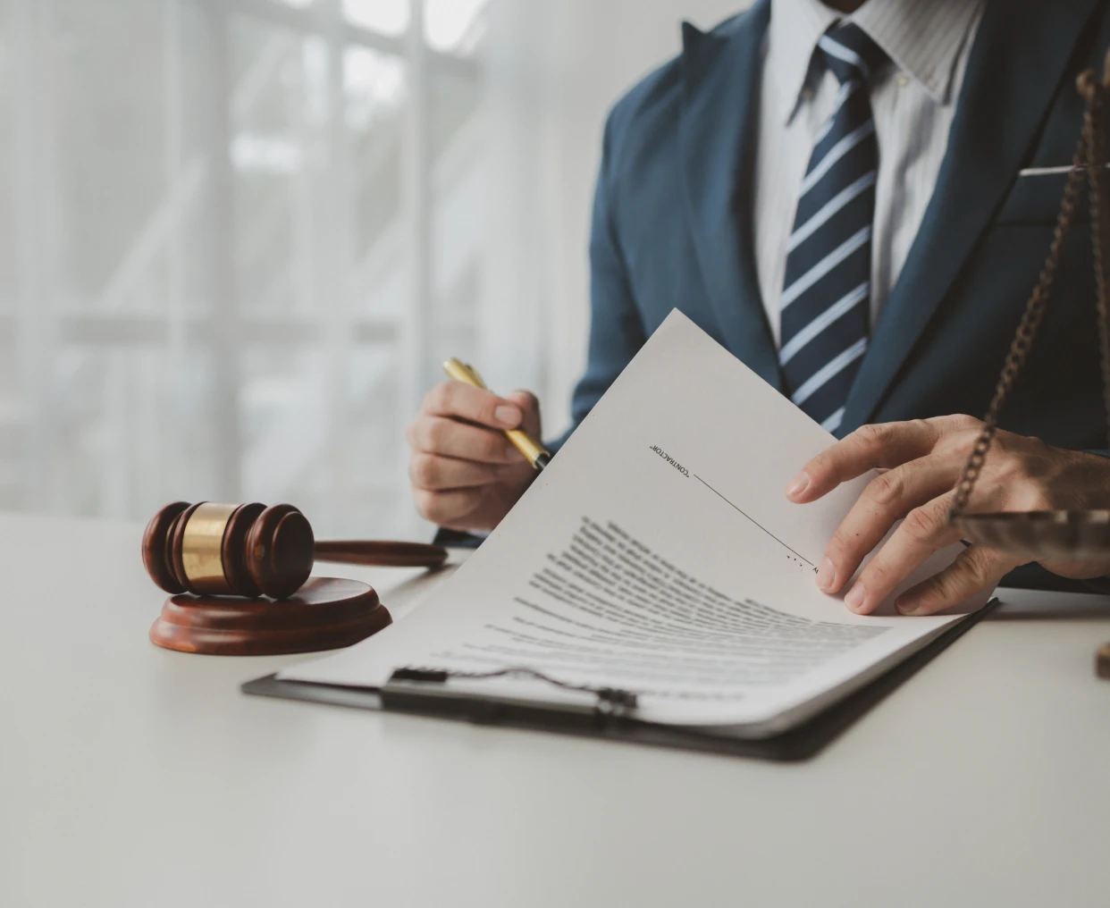 Lawyer reviewing legal documents at desk