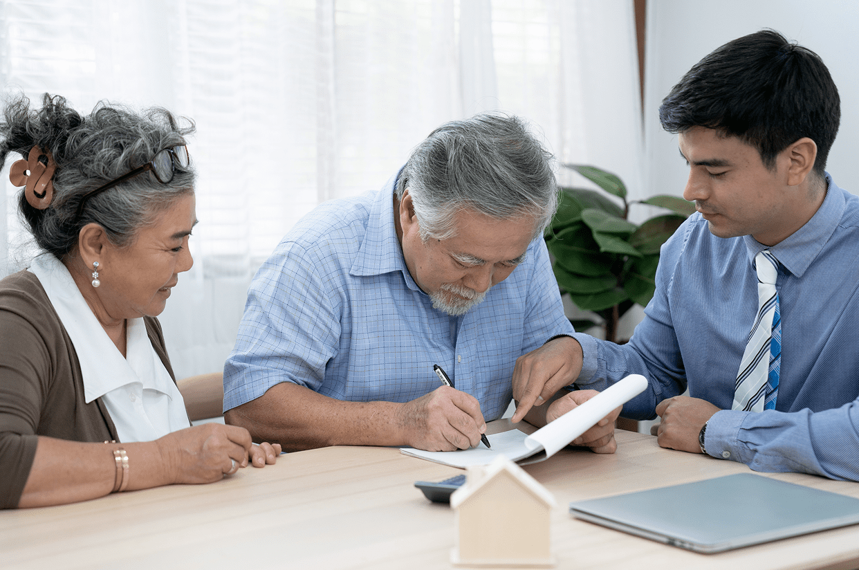 Senior couple discussing paperwork with consultant